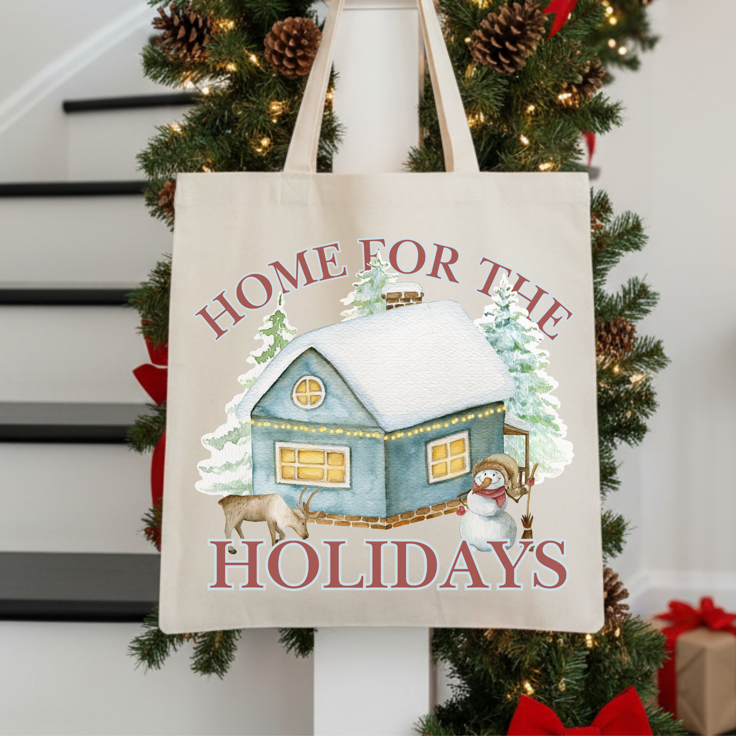 Tote bag with 'Home for the Holidays' design featuring a house and snowman.