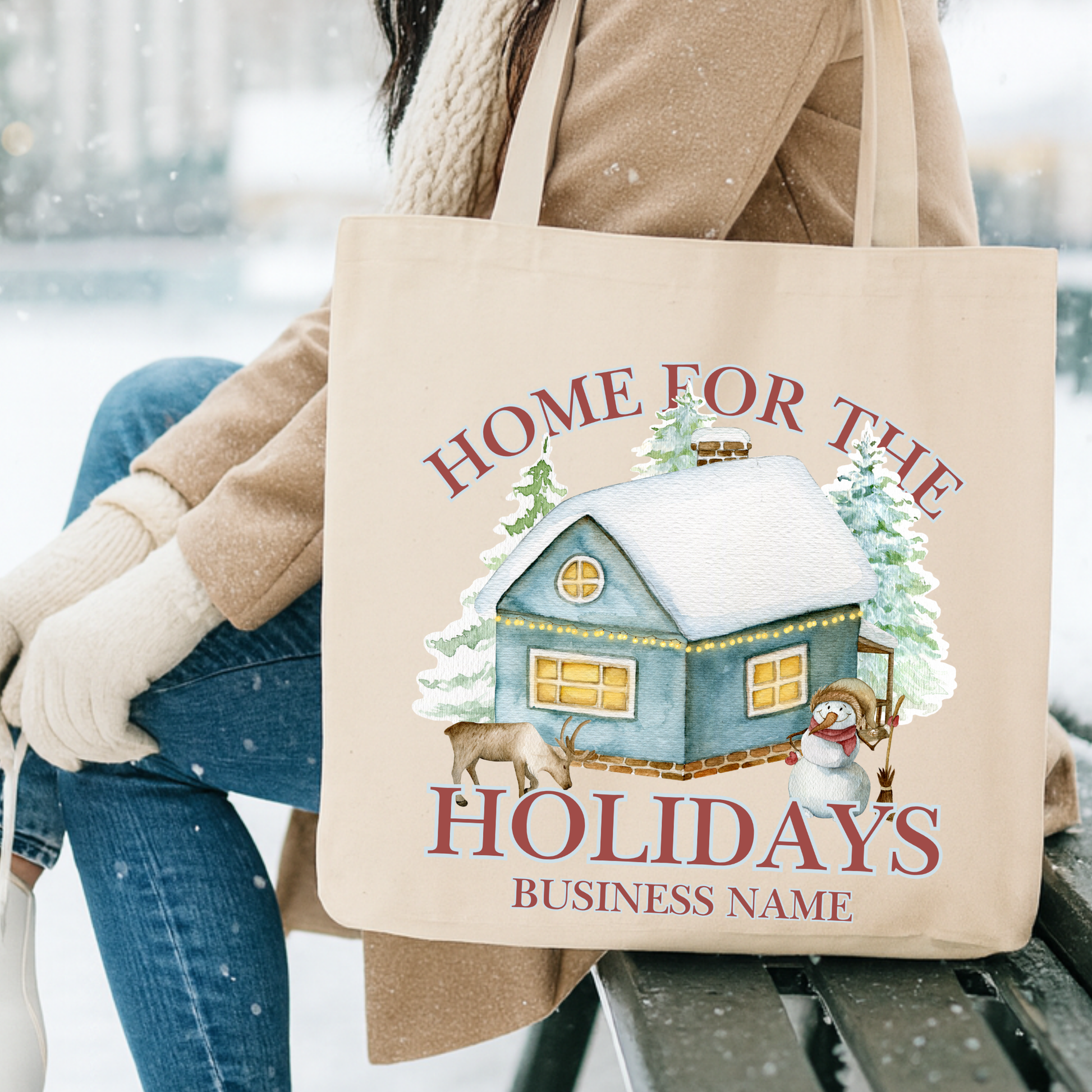 Canvas tote bag with a cabin, snowman and reindeer.  Tote says home for the holidays. Customizable tote with business name, city and state or both