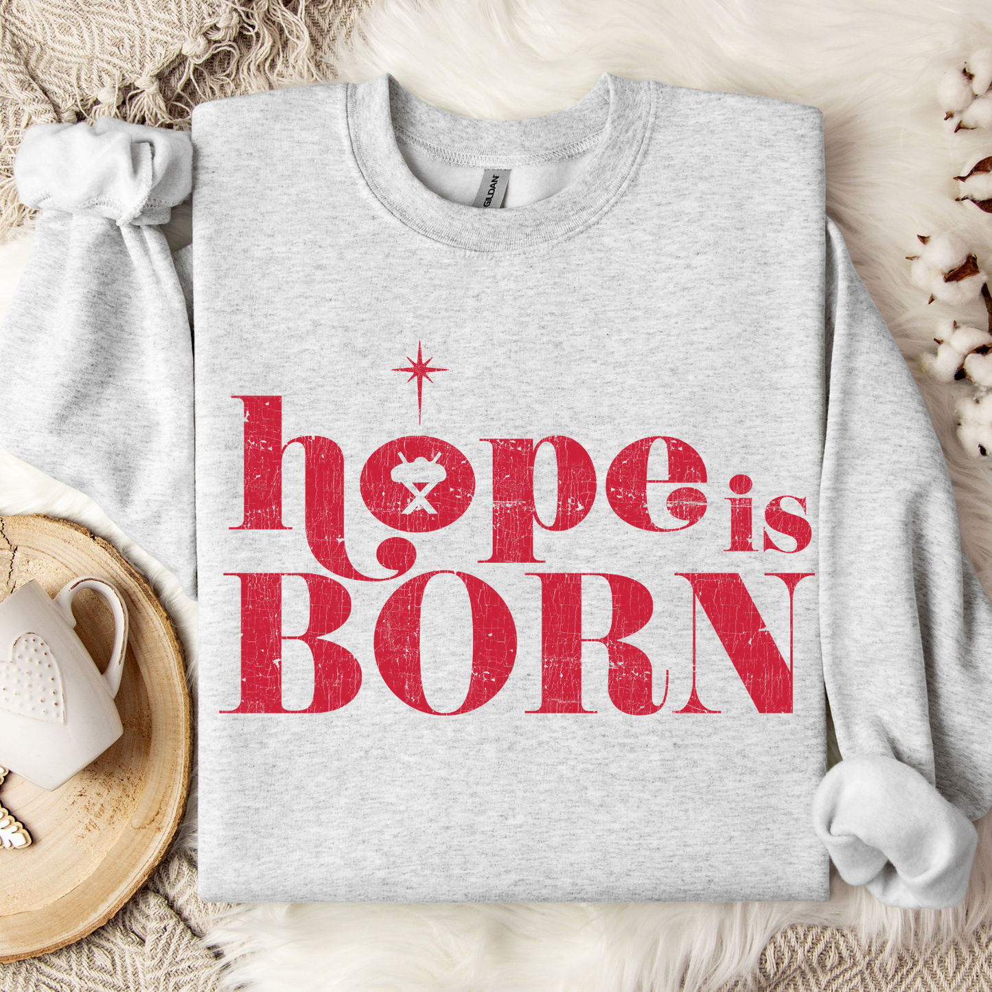 Hope Is Born Christian Christmas Graphic on a ash gray Sweatshirt