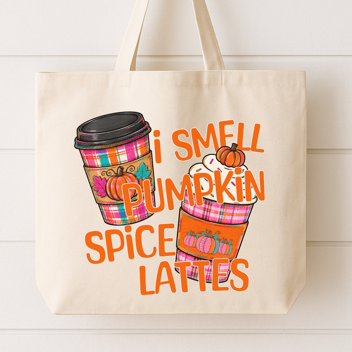 I smell pumpkin spice lattes fall coffee tote bag featuring two plaid coffee cups with cute pumpkin decorations on the sleeve of the cup