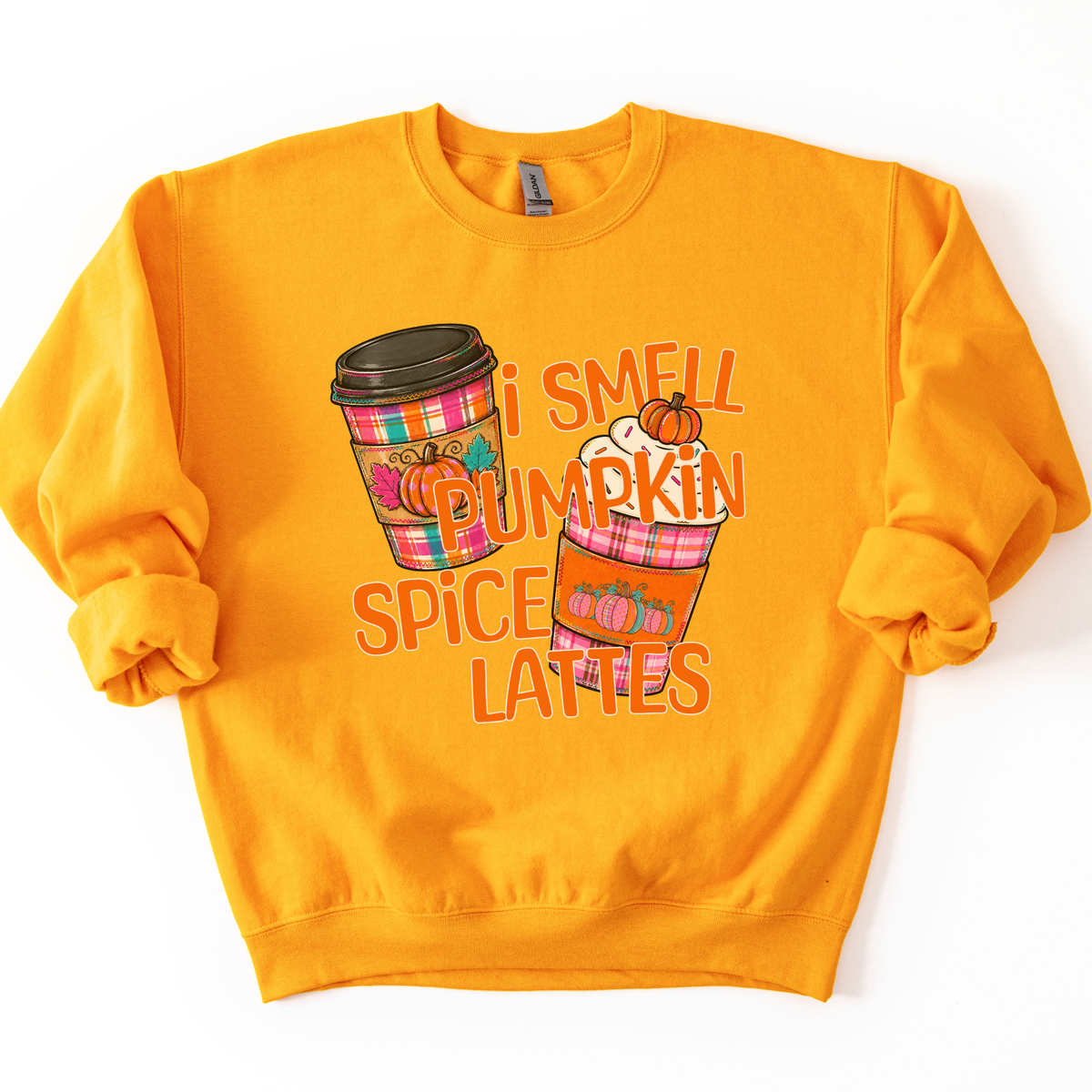 I smell pumpkin spice lattes featuring two coffee cups in fall plaid bright colors, orange, pink and teal with pumpkins on the sleeves of the cup warmers.  Gold sweatshirt