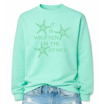 Mint Coastal sea life graphic on a classic crewneck sweatshirt. The design features three decorative starfish illustrations arranged around the phrase It Is Written In The Stars. Each starfish contains detailed swirl and sea life pattern elements that create a textured coastal look