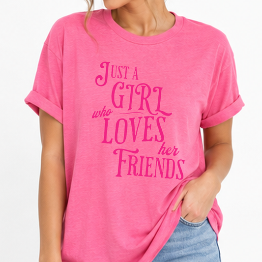 A woman wearing a bright pink heather t-shirt with rolled-up sleeves and a pink graphic text that reads 'JUST A GIRL who LOVES her FRIENDS'.