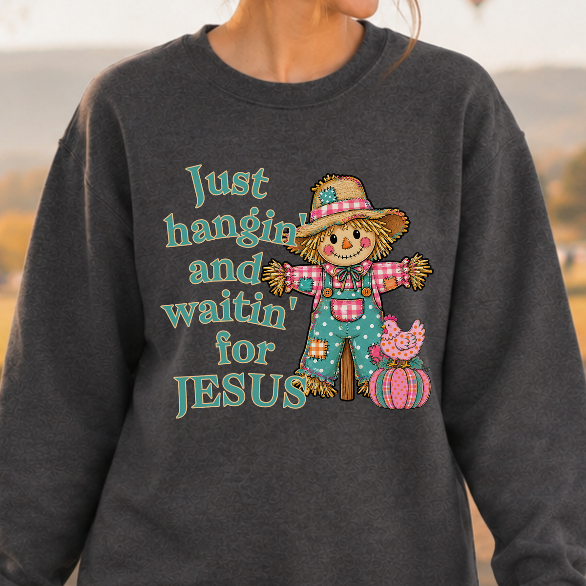 "Just hangin' and waitin' for Jesus" Cute fall scarecrow with blue polka dot bib overalls just hanging around with his cute little pumpkin and chicken at his side. Available on a gray sweatshirt
