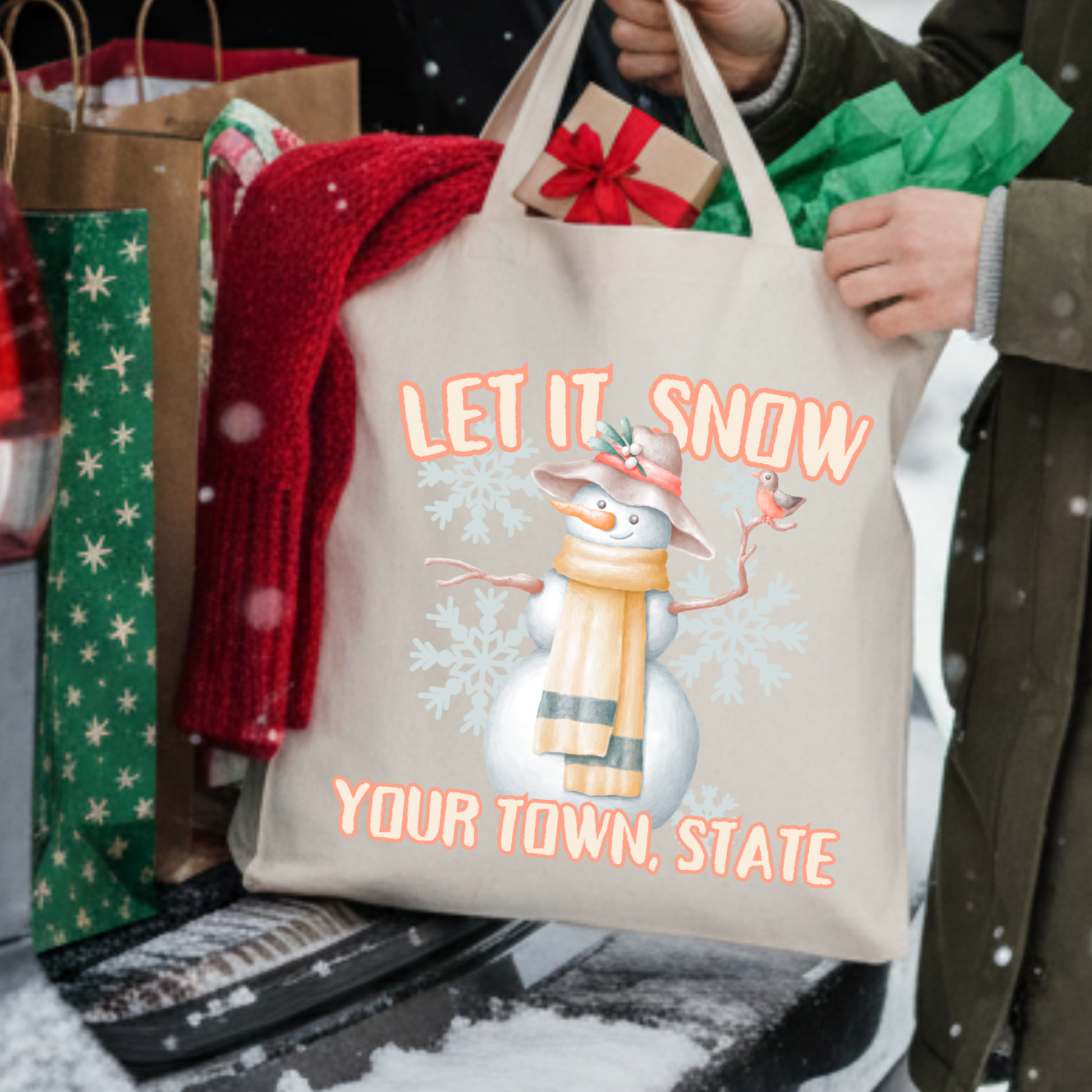 Canvas tote bag with a large snowman that says let it snow.  Customizable tote with business name, city and state or both