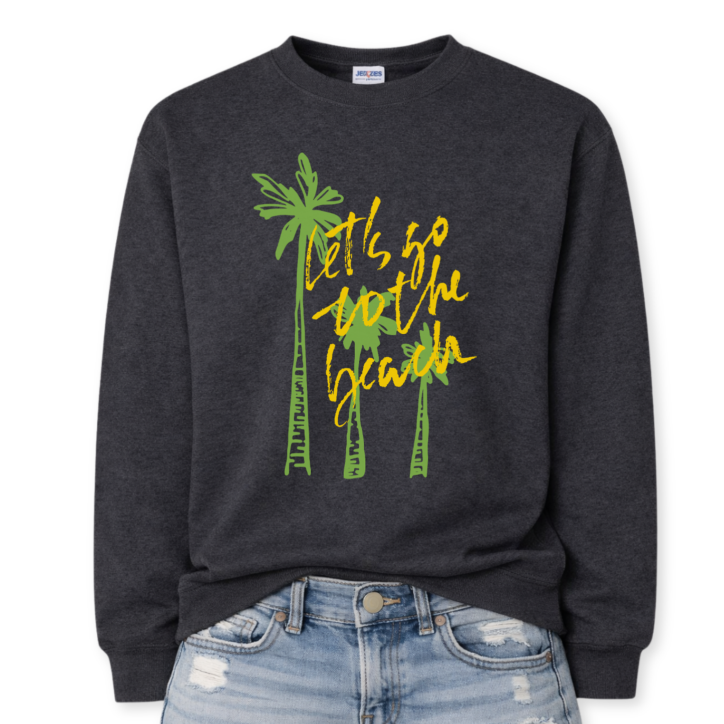Tropical beach graphic on a classic dark heather gray crewneck sweatshirt. The design features three tall palm trees with the phrase Lets Go To The Beach layered across the center in a bold script style. The vertical palm tree layout creates a strong tropical silhouette that immediately communicates beach vacation style.