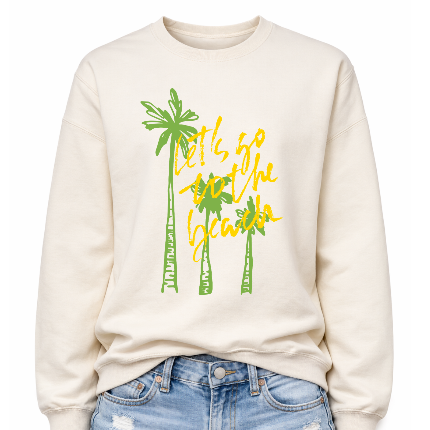 Tropical beach graphic on a classic off white crewneck sweatshirt. The design features three tall palm trees with the phrase Lets Go To The Beach layered across the center in a bold script style. The vertical palm tree layout creates a strong tropical silhouette that immediately communicates beach vacation style.