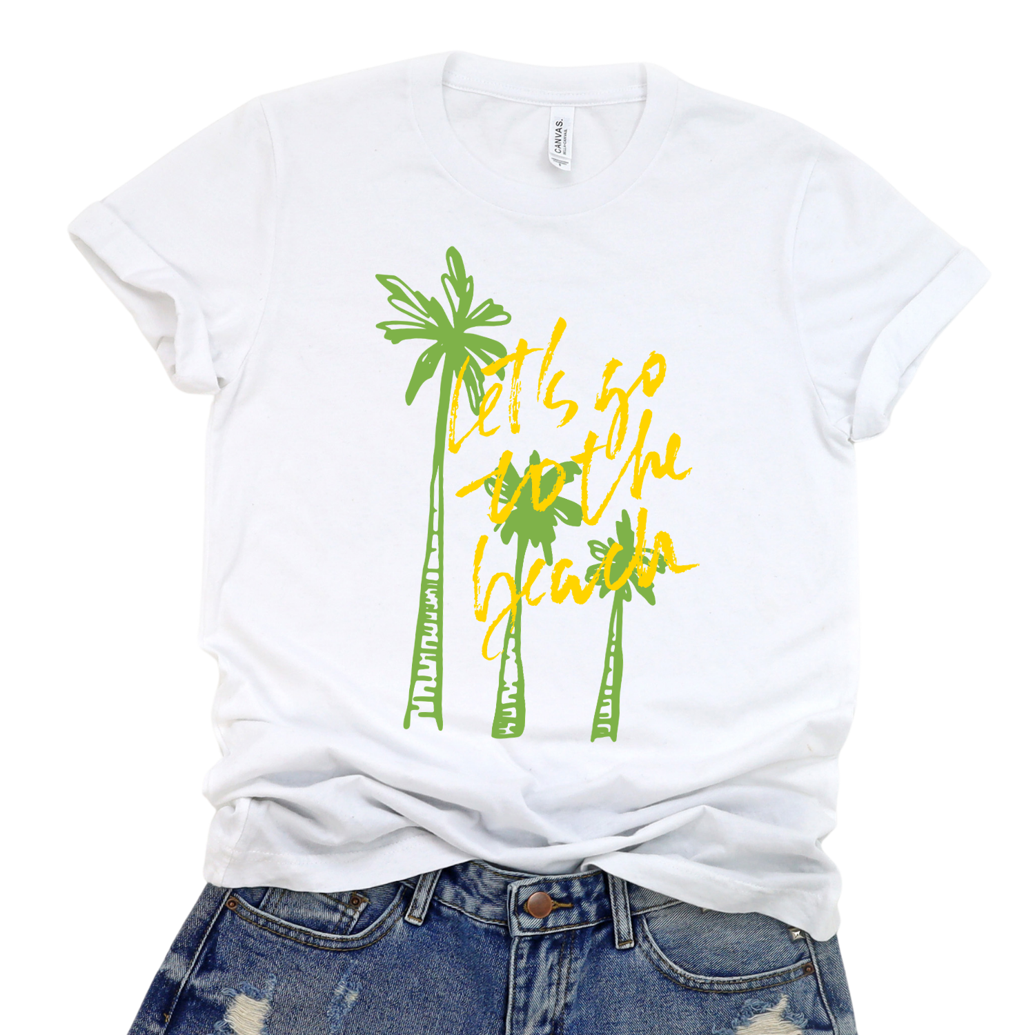 Summer beach graphic on a soft unisex white graphic tee. The design features three hand sketched palm trees in bright green with bold yellow script reading Lets go to the beach layered over the palms. 