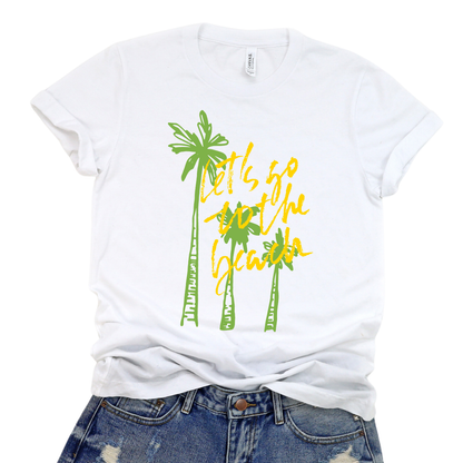 Summer beach graphic on a soft unisex white graphic tee. The design features three hand sketched palm trees in bright green with bold yellow script reading Lets go to the beach layered over the palms. 