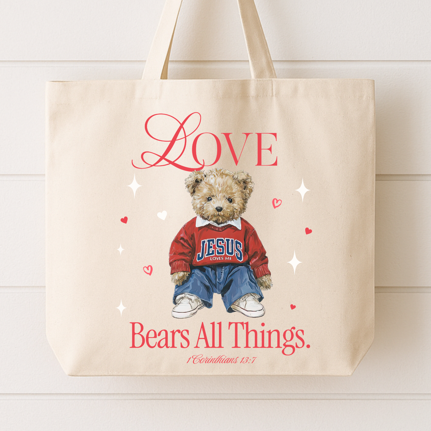 Beige tote bag with teddy bear graphic and text on a white background