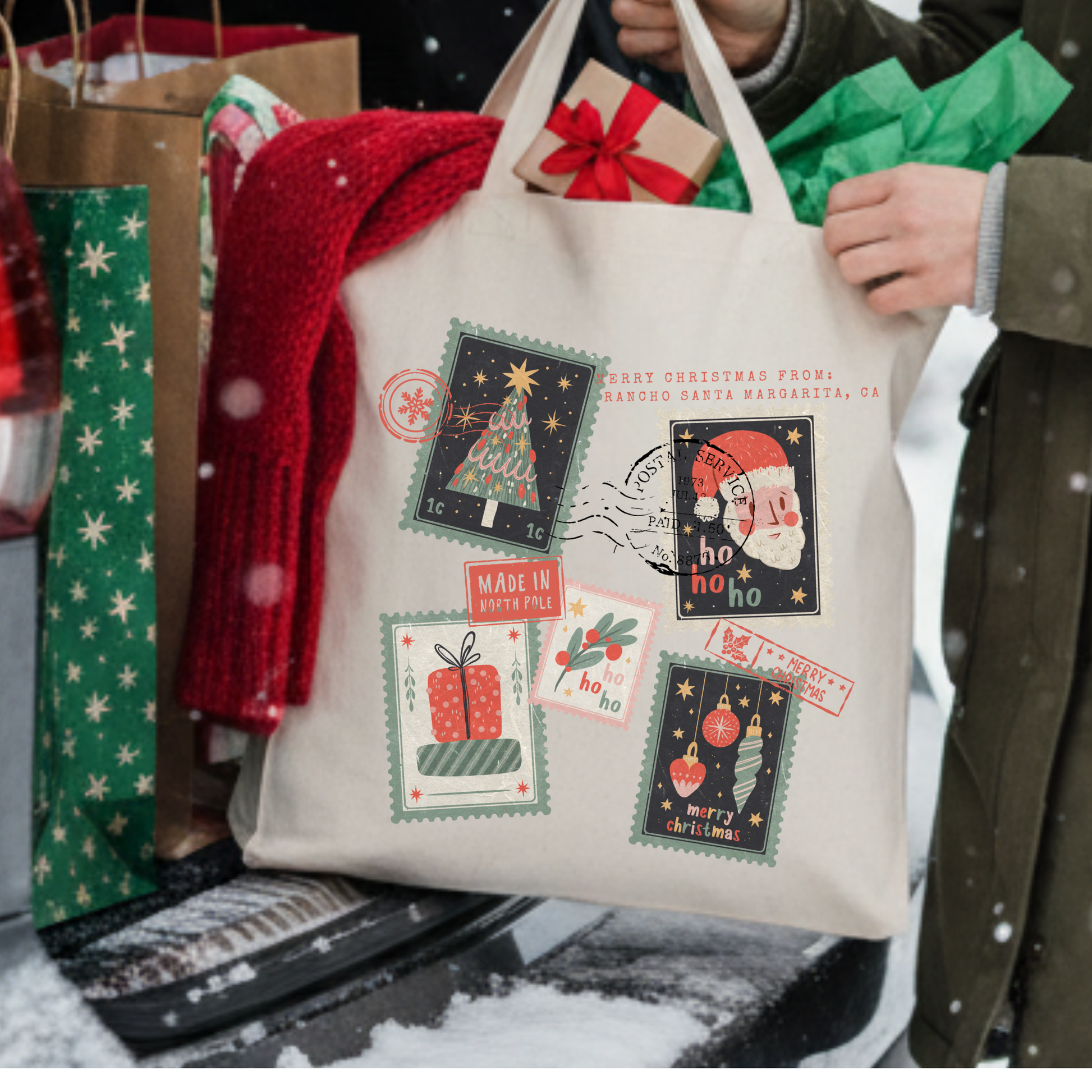 Canvas tote bag with Christmas themed stamps scattered.  Customize it with business name or city and state