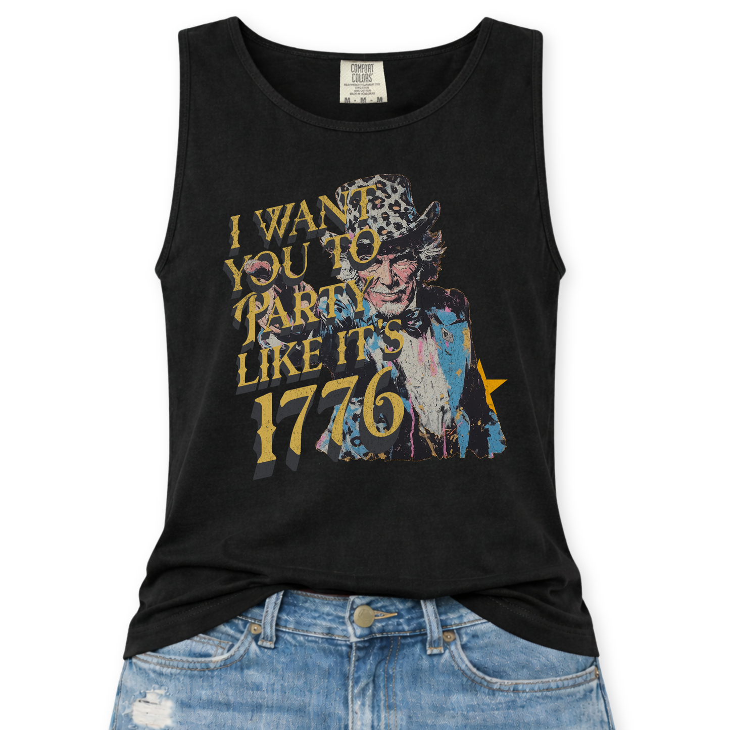 black Comfort Colors tank top featuring a distressed vintage Uncle Sam graphic with the phrase “I Want You To Party Like It’s 1776” in layered gold and dark lettering, styled in a flat lay mockup with light wash denim jeans.