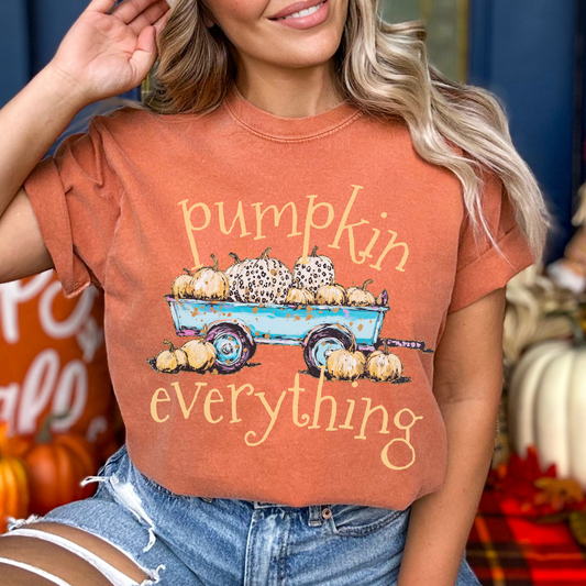 a wagon full of pumpkins with the saying pumpkin everything on a yam color comfort colors tee