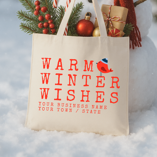 Warm winter wishes with a red bird and a blue beanie hat sitting on the words.  Personalize the bag with business information