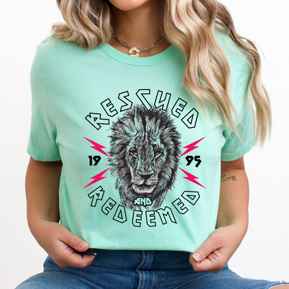 Rescued and Redeemed Christian graphic t-shirt featuring a lion on a Heather mint t-shirt