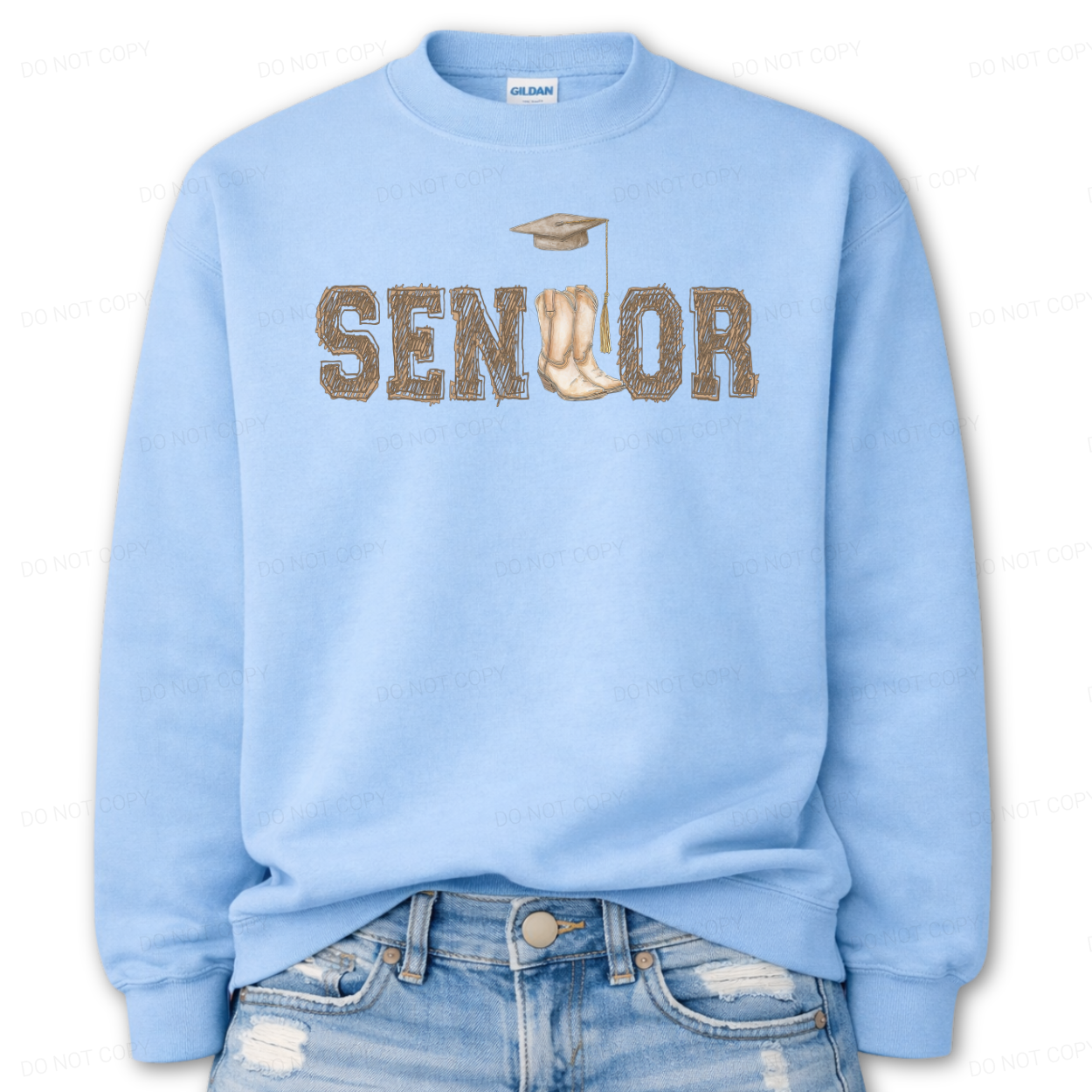Western graduation graphic on a classic blue crewneck sweatshirt. The design features SENIOR in bold varsity style lettering with a pair of cowboy boots integrated into the wordmark and a small graduation cap detail above,