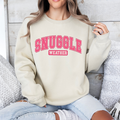 pink snuggle weather on a sand color sweatshirt