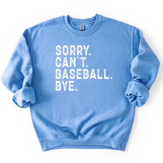blue crewneck sweatshirt with distressed white text reading “SORRY. CAN’T. BASEBALL. BYE.” laid flat with sleeves slightly scrunched.