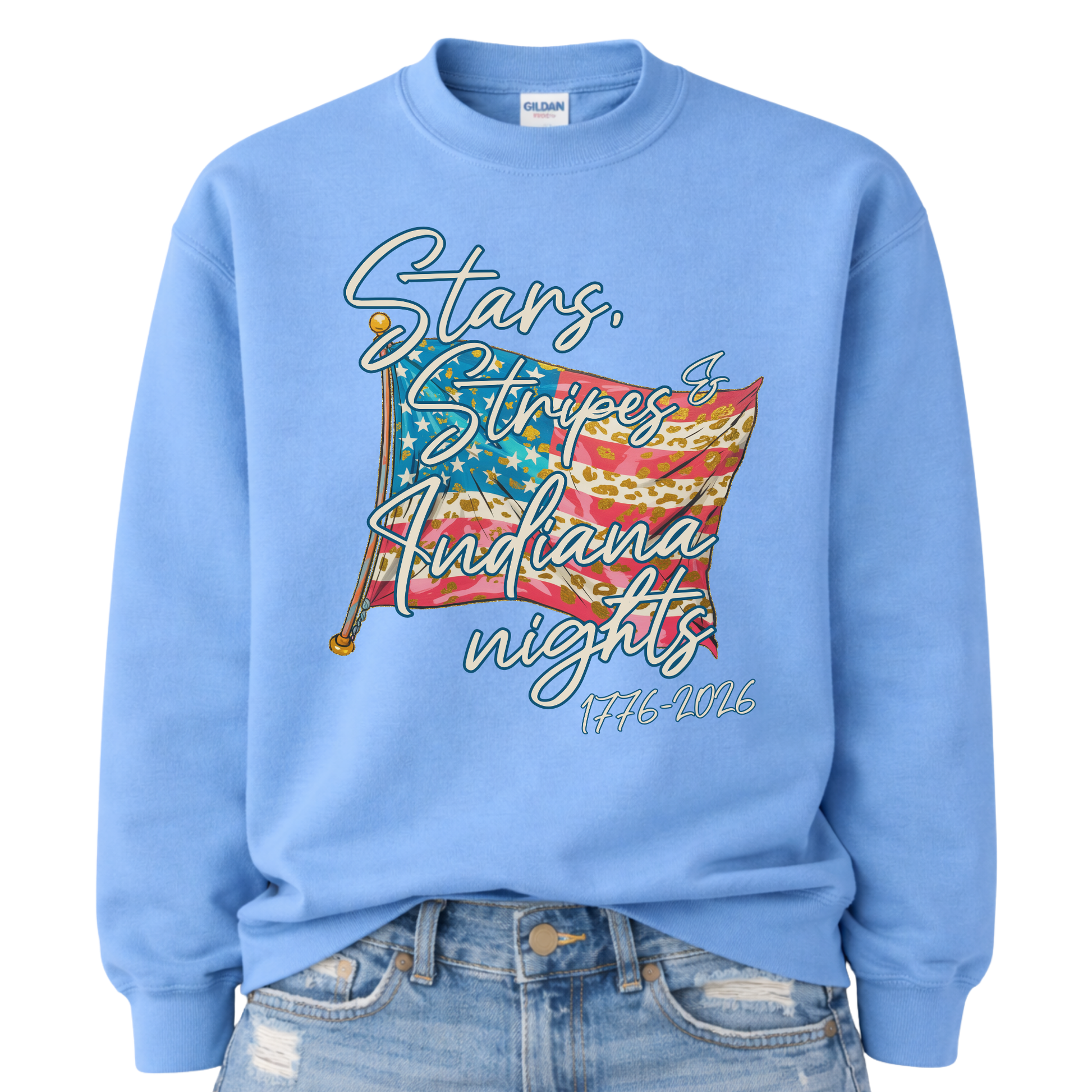 Patriotic stars and stripes graphic on a blue sweatshirt. The artwork shows a waving American flag with stars, striped details, and leopard-print accents, paired with script lettering that reads “Stars, Stripes & ___ Nights” plus “1776–2026” for a bold Fourth of July and summer patriotic look. Customizable location option: add any City or State (up to 30 characters) to make it a hometown, vacation spot, or event-ready USA piece.