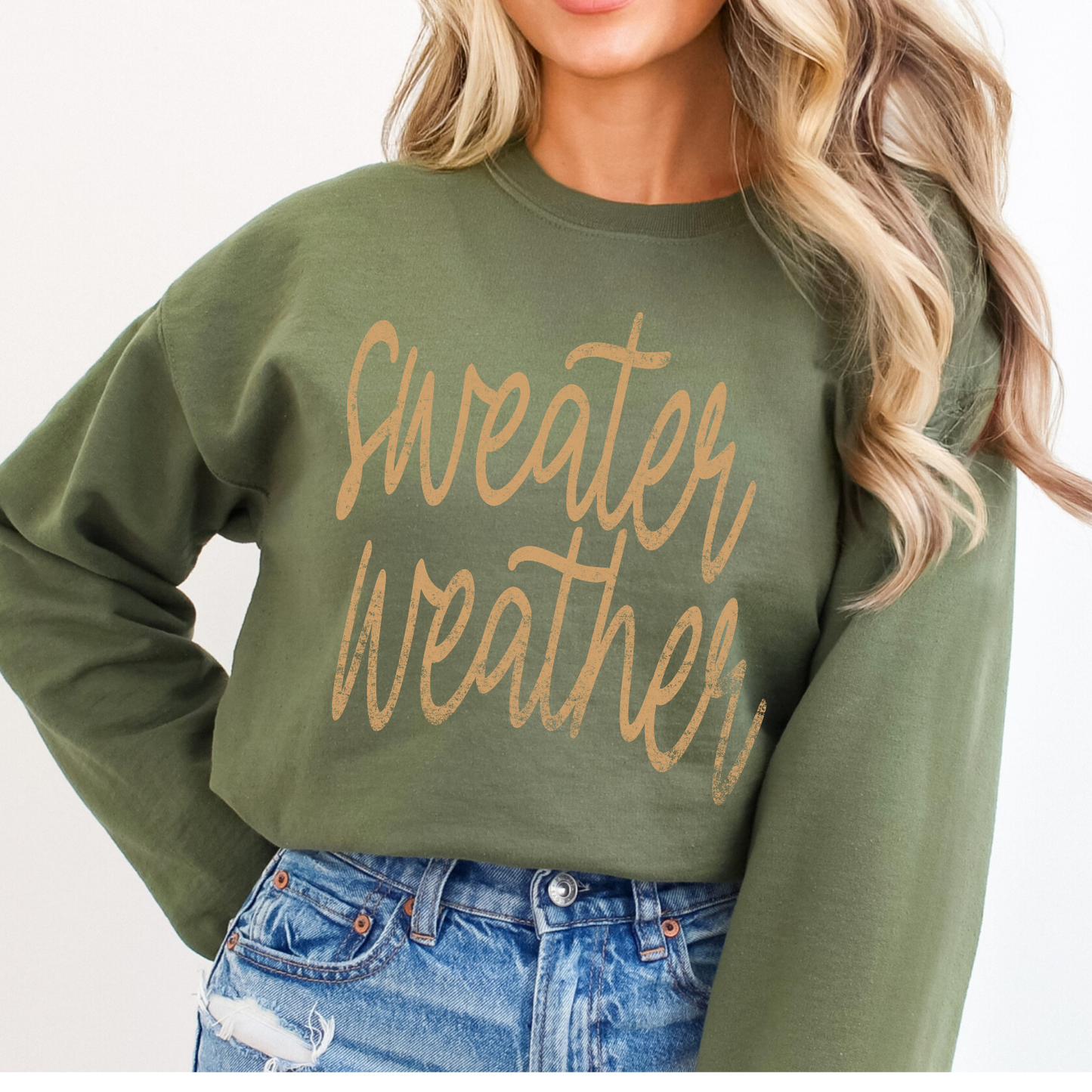 Green sweatshirt with 'Sweater Weather' text worn by a person, against a plain background
