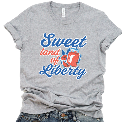 A gray t-shirt with a graphic that reads 'Sweet land of Liberty' accompanied by an image of an American flag and a freedom bell.