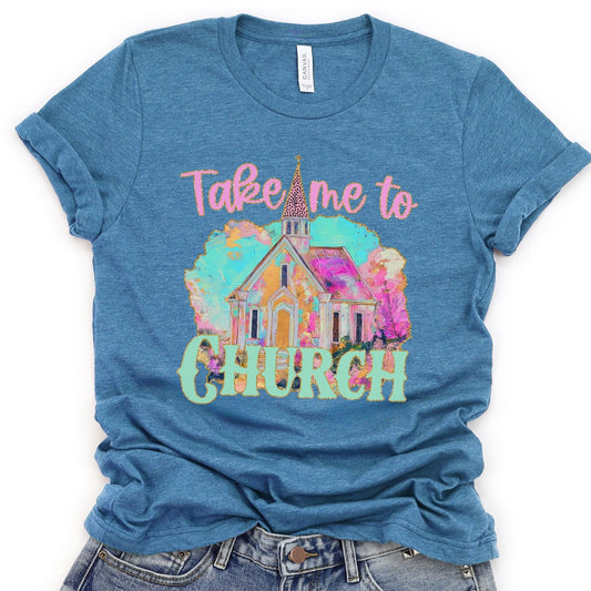 Blue t-shirt with a colorful graphic of a church and text 'Take me to Church' on a white background.