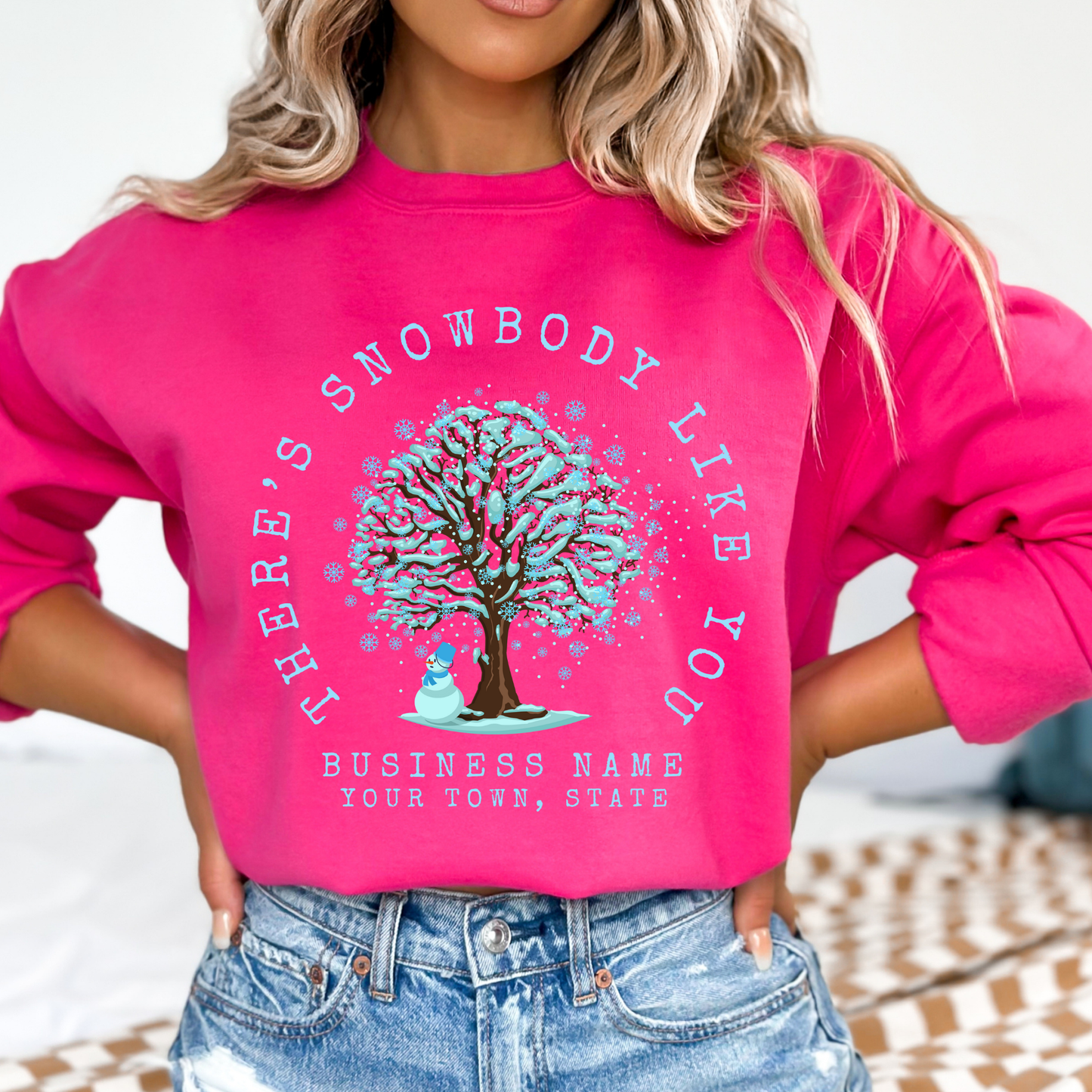There's snowbody like you text wrapped around a tree with branches full of blue snow and a snowman underneath.  customize with business name, city or town or both.   heliconia pink sweatshirt
