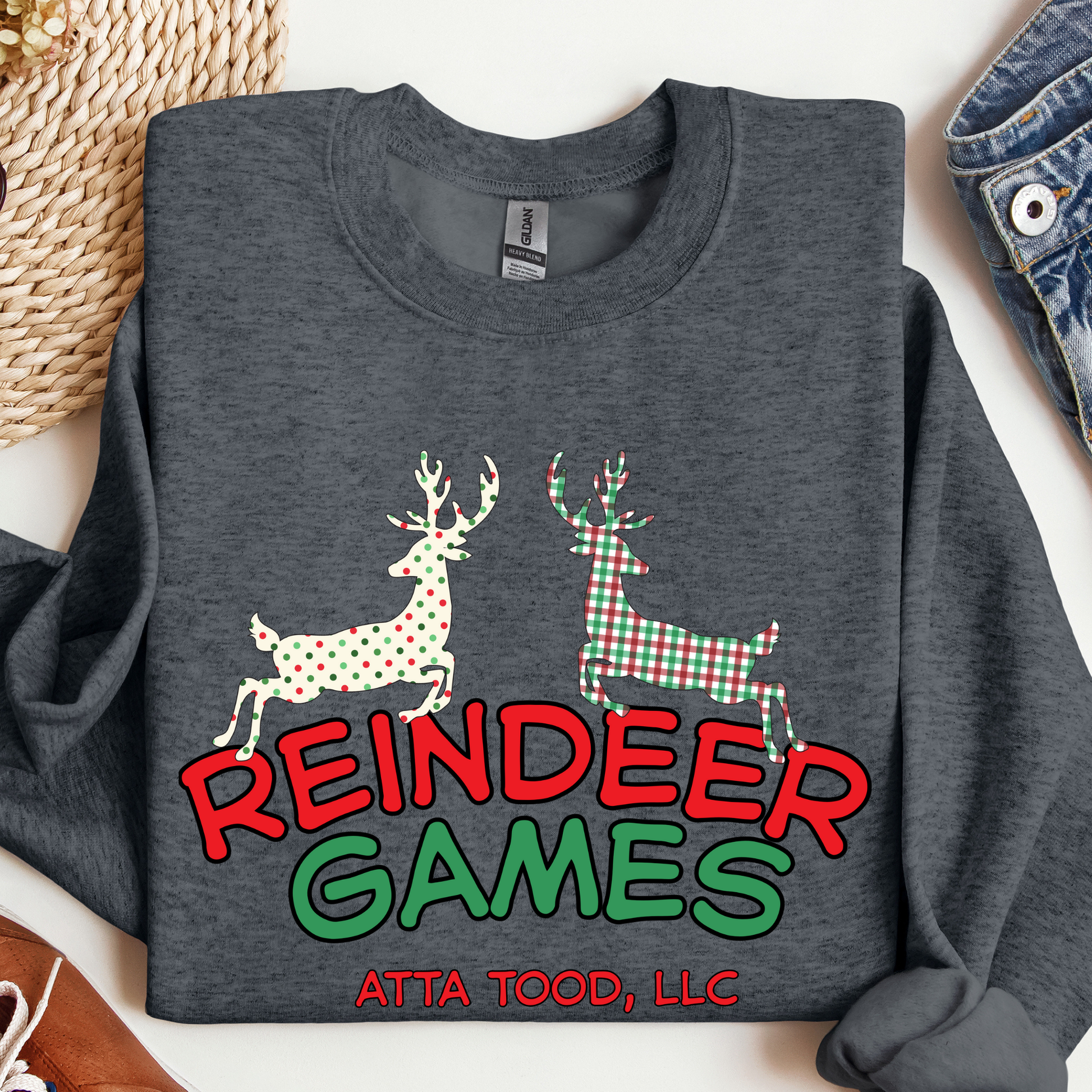 dark gray sweatshirt with 'Reindeer Games' with a red and green plaid reindeer and a polka dot christmas color reindeer.  below image you can customize with your business name, city and state or both