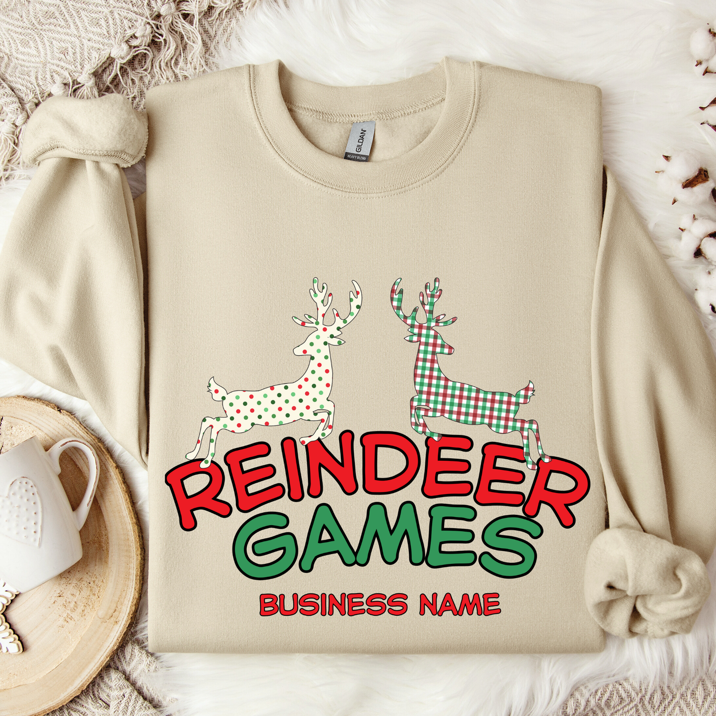 sand sweatshirt with 'Reindeer Games' with a red and green plaid reindeer and a polka dot christmas color reindeer.  below image you can customize with your business name, city and state or both