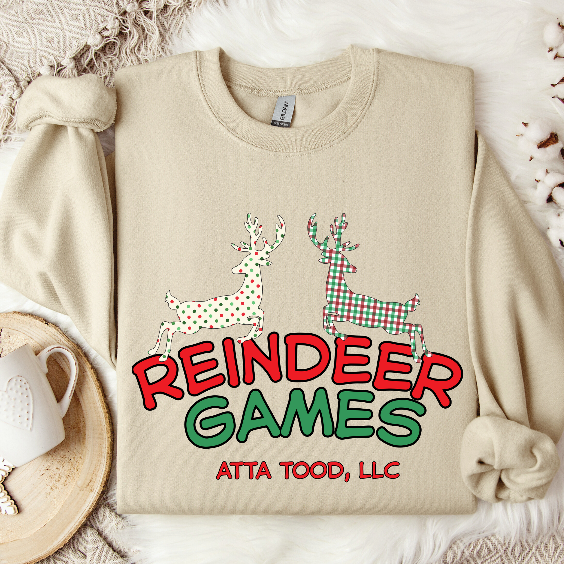 sand sweatshirt with 'Reindeer Games' with a red and green plaid reindeer and a polka dot christmas color reindeer.  below image you can customize with your business name, city and state or both