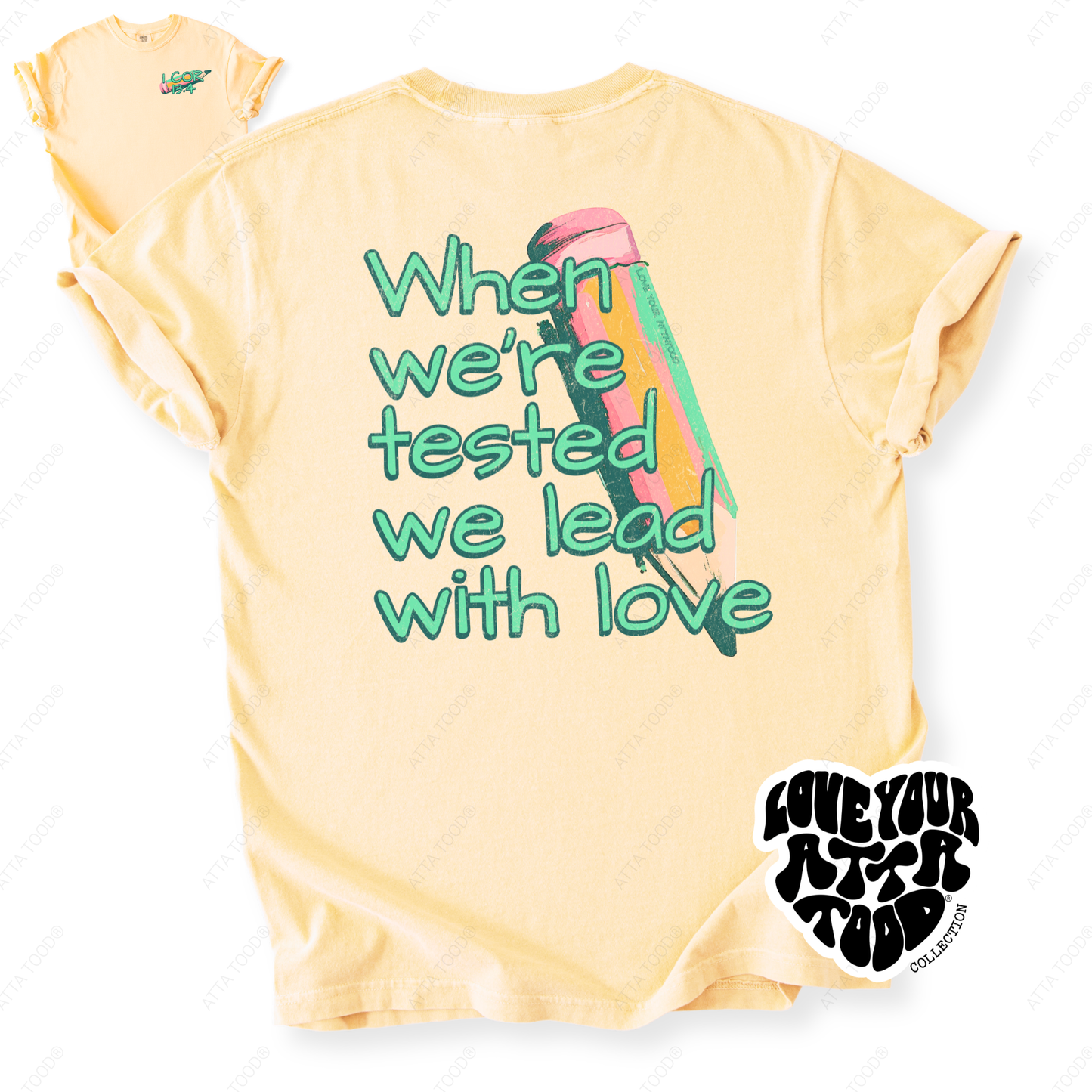 Painted pencil graphic with encouragement text “When We Are Tested We Lead With Love,” thick paint texture and high-contrast color, printed on a Comfort Colors® tee.